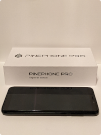 a shot of the PinePhone Pro box, and Pro itself, on a white background.